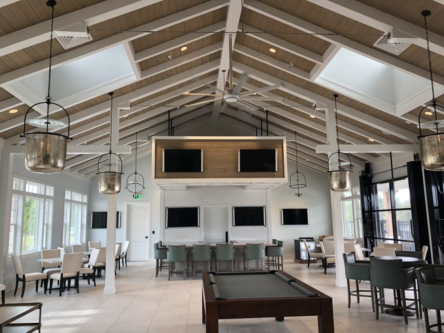 Spacious, modern lounge with high ceilings and multiple seating areas.